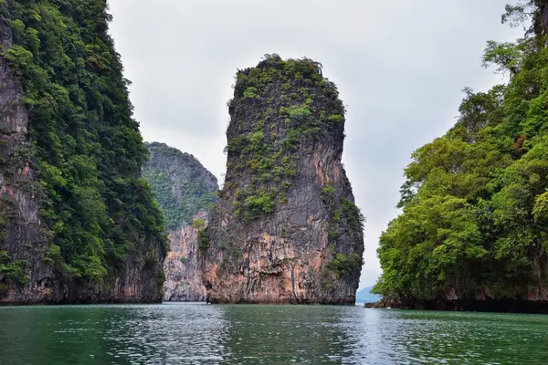 Island, Ocean views near Phuket Thailand with Blues, Turquoise and Greens oceans, mountains, boats, caves, trees resort island of phuket Thailand. Including Phi Phi, Ko Rang Yai, Ko Li Pe and other islands. Asia.