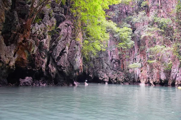 Island, Ocean views near Phuket Thailand with Blues, Turquoise and Greens oceans, mountains, boats, caves, trees resort island of phuket Thailand. Including Phi Phi, Ko Rang Yai, Ko Li Pe and other islands. Asia.