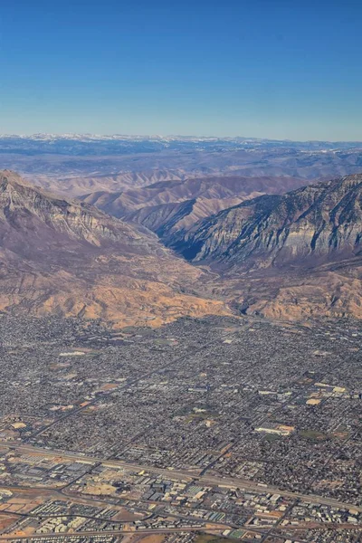 Wasatch Front Rocky Mountain Range Aerial view from airplane in fall including urban cities and the Great Salt Lake around Salt Lake City, Utah, United States of America. USA.