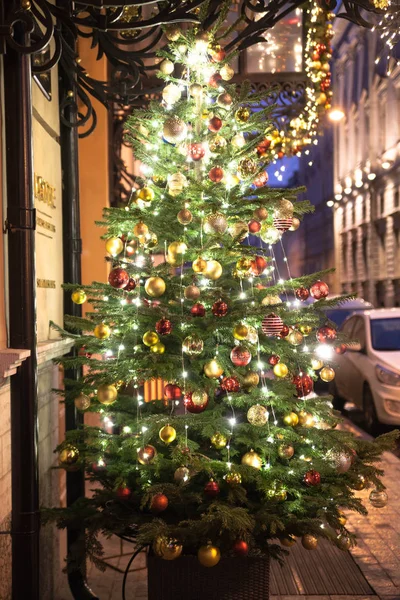 A beautifully decorated Christmas tree on the street.
