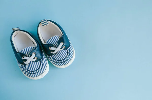 Baby pojke skor, barndom koncept på pastell blå bakgrund, ovanifrån. Stockfoto