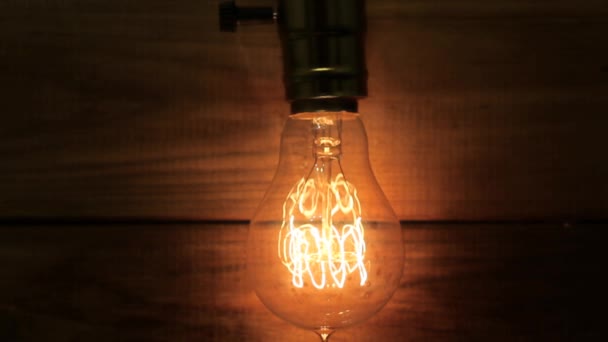 Old vintage Edisons light bulb gradually defocused and transformed into bokeh. — Stockvideo