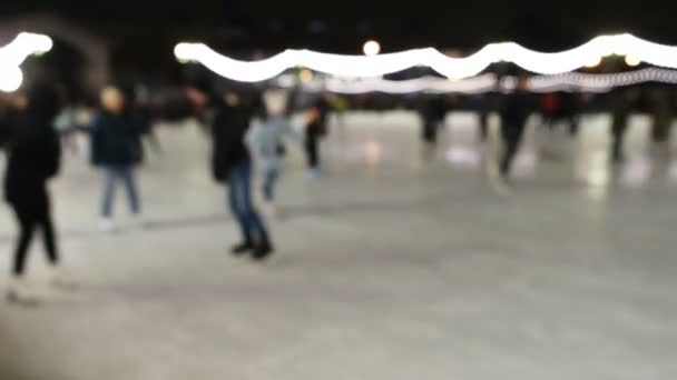 Blurred people skate outdoors on skates on ice, 4K. — Stock Video