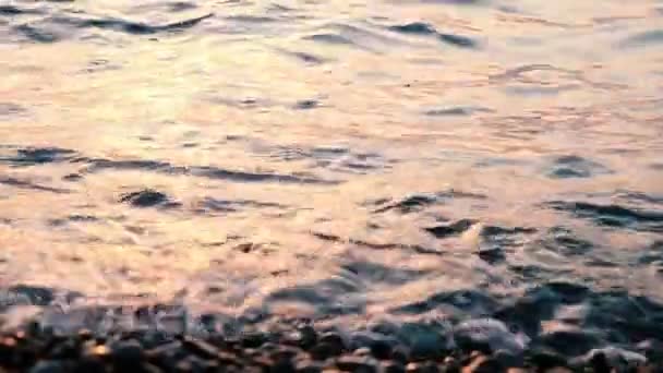 Ağır çekim yakın çekim batımında dalgalar deniz — Stok video