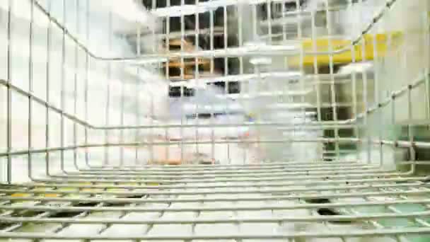 Time-lapse shot from the grocery cart in the supermarket, the cart skates in the store - the concept of consumerism — Stock Video