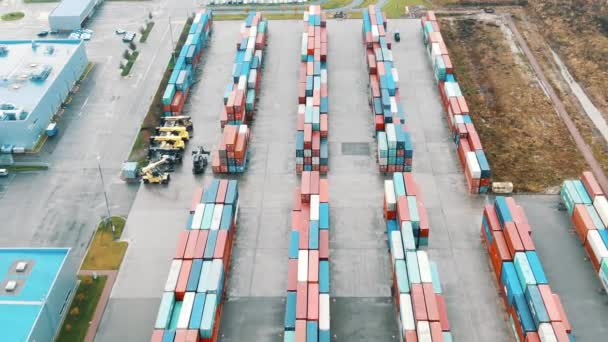 Cargo container stacks on open ground by warehouse upper — Stock Video