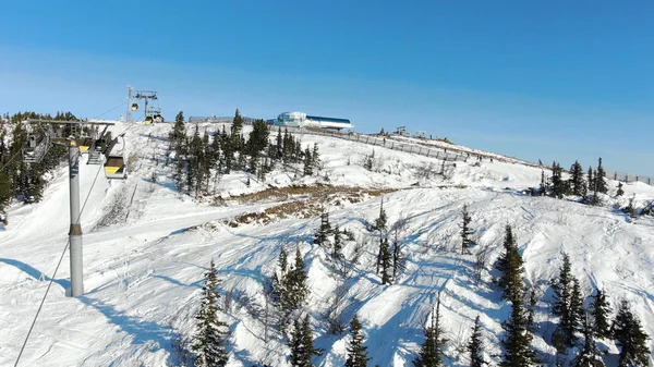 ski lift cabins with tourists move to hilltop with track