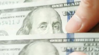 Küresel ekonomik kriz, durgunluk, koronovirüs ve petrol yüzünden 100 Amerikan doları sayan bir adam.