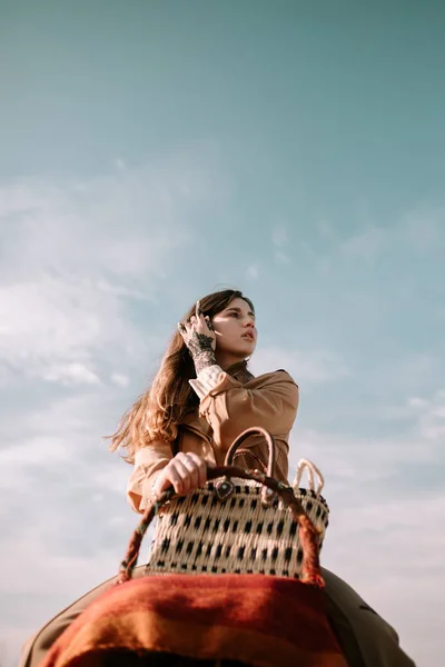 Young woman riding on camel