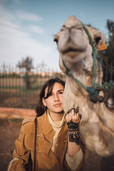 Young woman with a camel in Morocco