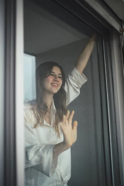 Beautiful woman smiling in the window