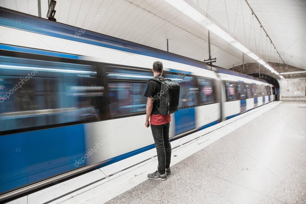 Man at the subway station with a backpack