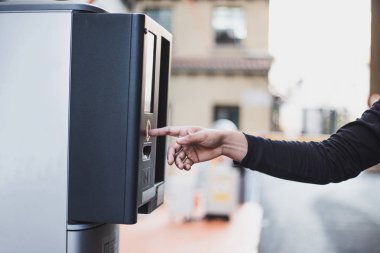 Taking a ticket from the parking machine clipart