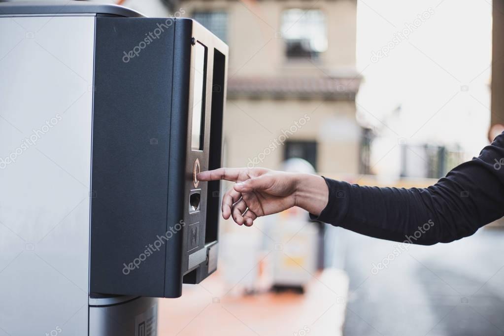 Taking a ticket from the parking machine