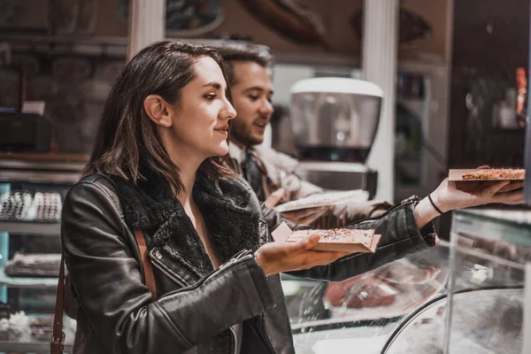 Friends buying pizza. Friends having a good time eating pizza