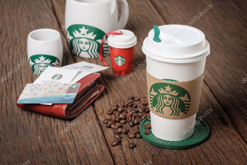 BANGKOK, THAILAND - APRIL 23, 2015: White paper cup and other gift with Starbucks logo. Starbucks is the world's largest coffee house with over 20,000 stores in 61 countries.