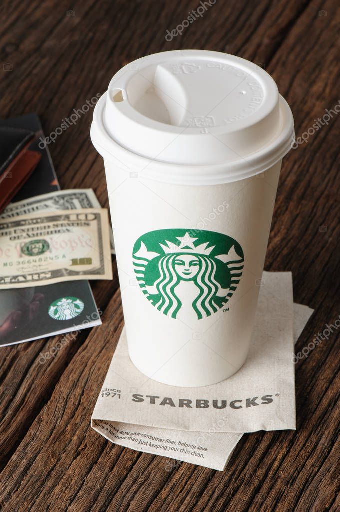 BANGKOK, THAILAND - JULY 15, 2015: White paper cup with Starbucks logo. Starbucks is the world's largest coffee house with over 20,000 stores in 61 countries.