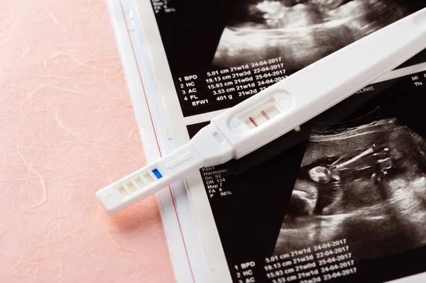 closeup pregnancy test with positive pregnant