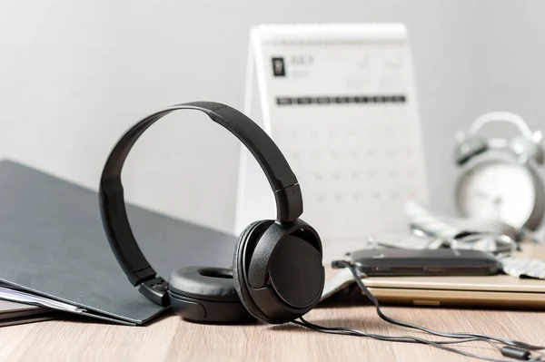 wired black headphone isolated on the desktop