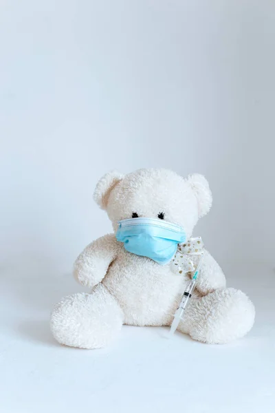 stock image soft toy in a medical mask on a white background