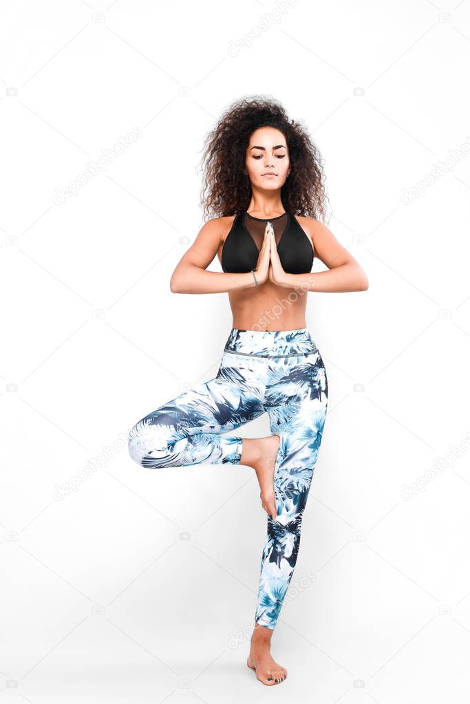 Yogini in sport outfit on white background