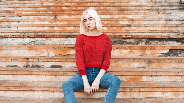 Blonde girl sitting on rusty stairs — Stock Photo, Image