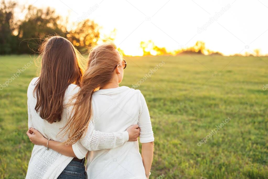 Young girls on field in sunlight
