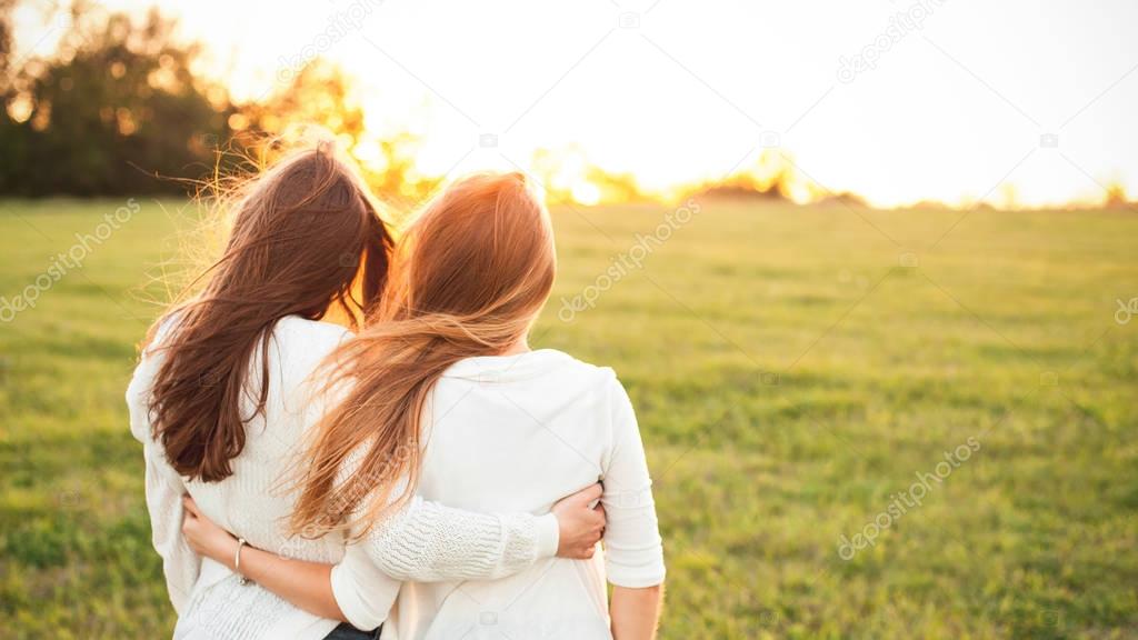 Young girls on field in sunlight