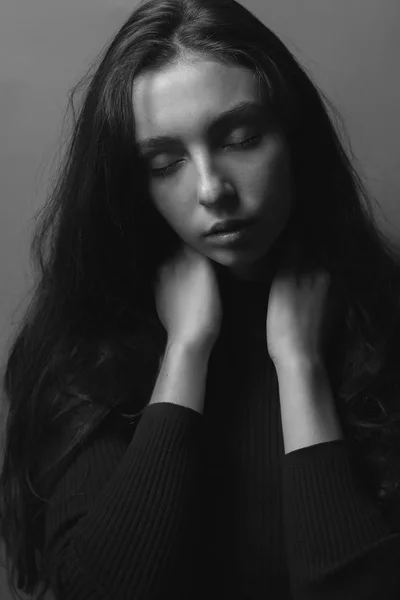 black and white portrait of young woman with closed eyes