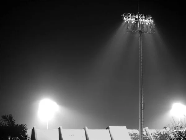 Black and white sport stadium\'s spotlights at night