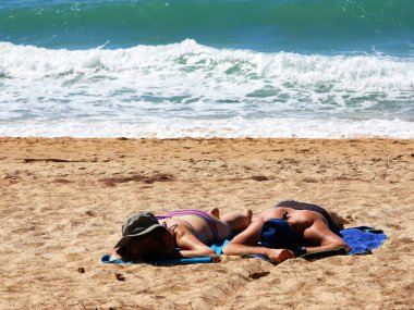 Mai Khao Beach rüzgarlı bir plaj bronzlaşma çift güneş