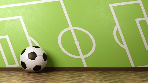 Футбольный мяч против зеленой стены с футбольным полем — стоковое фото