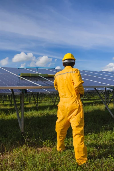 technician operating and cleaning solar panels at generating pow