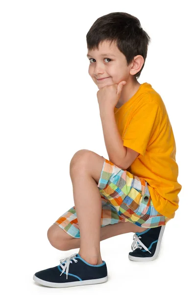 Smiling boy sits on the floor — Stock Photo, Image