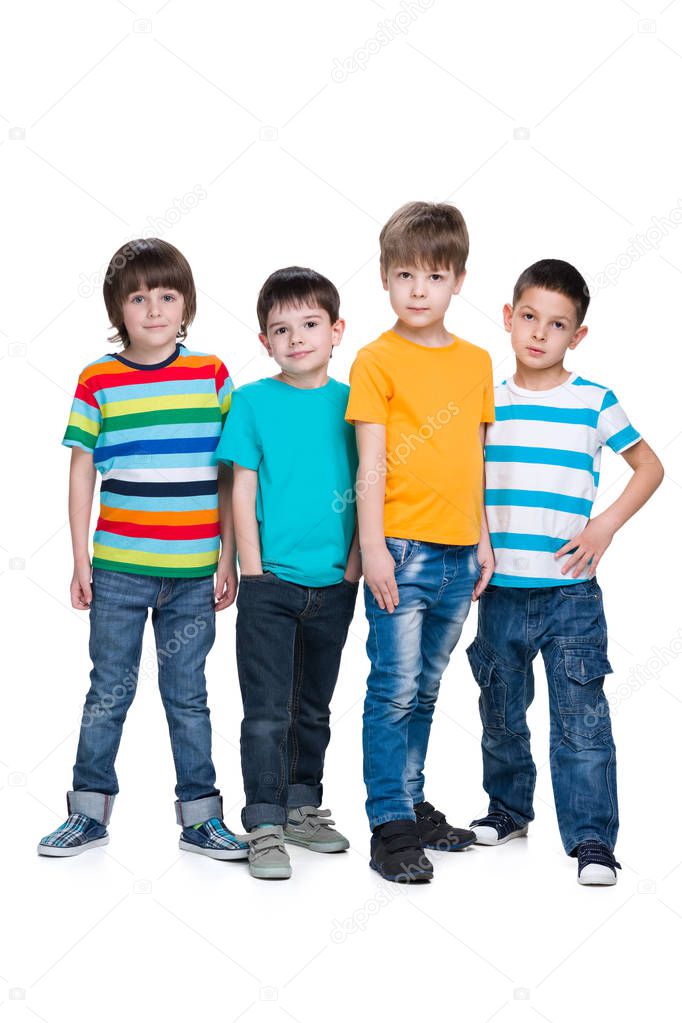 Four fashion young boys are standing together