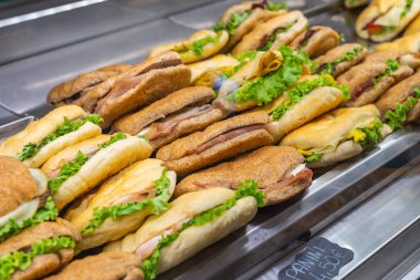 Ham sandwich and vegetables for sale in pastry shop