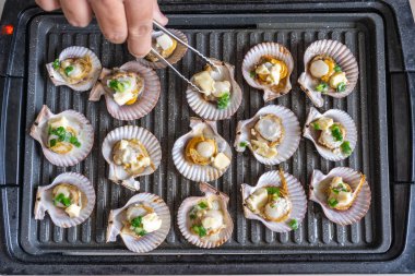Elektrikli fırında yeşil soğan ve peynirli ızgara midye.
