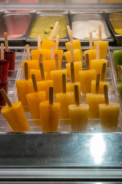 Tasty yellow frozen mango ice pop in the freezer