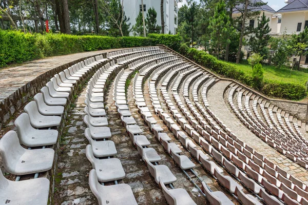 Vacant plastic white chairs at outdoor arena — Stock Photo, Image