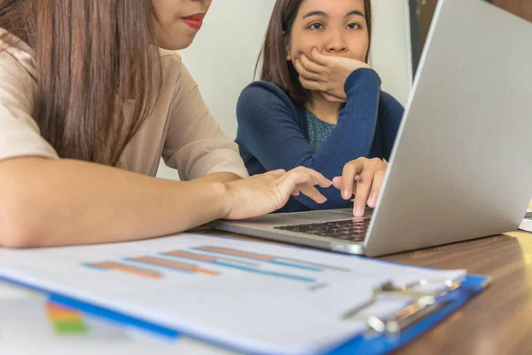 Asian employees using laptop while discuss about business project