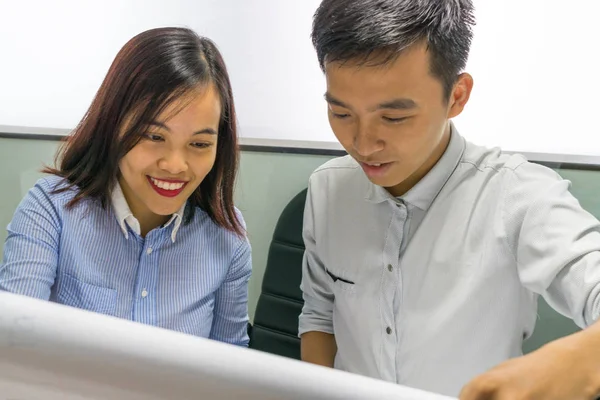 Asian business employees discuss about work on paper