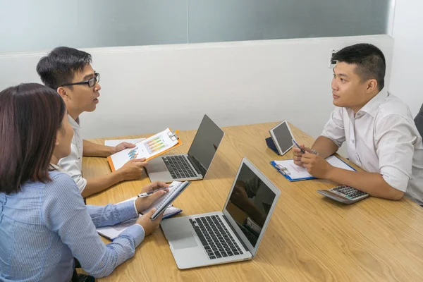 Asian businesspeople having discussion in meeting room