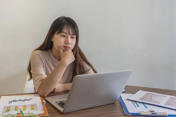 Asyalı çalışan dizüstü bilgisayardaki verilere bakıyor — Stok fotoğraf