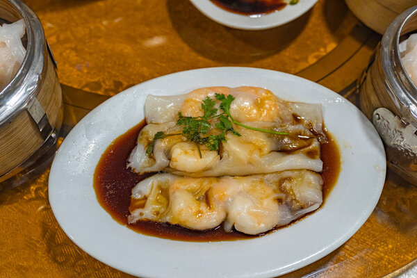 Plate of delicious Chinese dimsum- steamed shrimp rice rolls 
