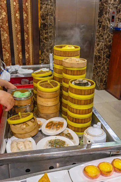 Assorted dimsum dumplings and rolls in Chinese bamboo steamer boxes — Stock Photo, Image