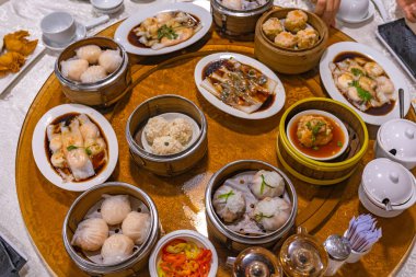 Hong Kong steamed dumplings and rice rolls in dimsum restaurant clipart