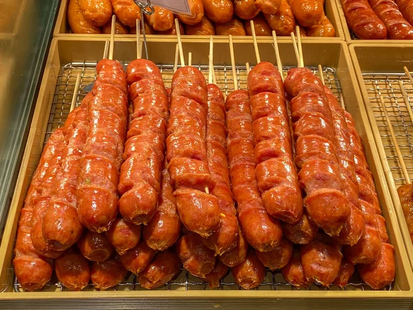 Delicious fried hotdog skewers for sale at street food market — Stock Photo, Image