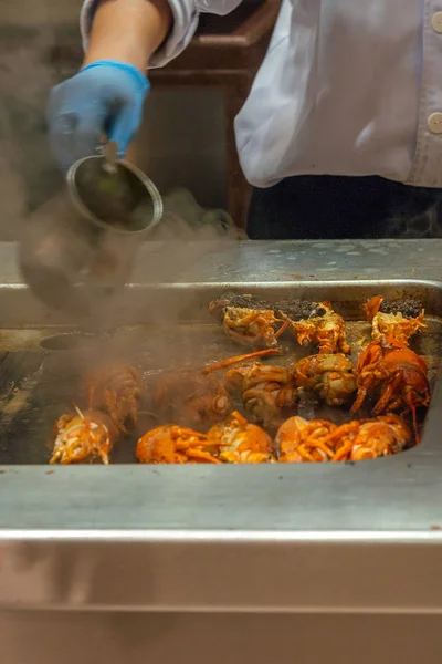Vertical photo of chef grilling delicious crayfish on smoky stove — 스톡 사진