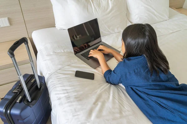 Businesswoman working on laptop in the hotel room