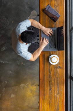 Vertical high angle view photo of businessman typing laptop